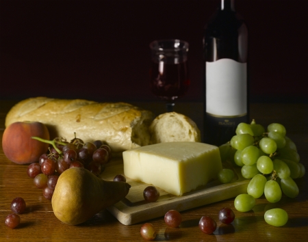 Wine, Cheese, Bread, Fruits on a tableの写真素材
