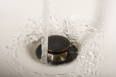 Water going down the drain in a sink basin