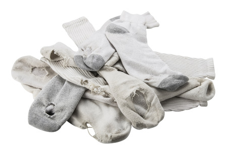 Pile of old white socks with holes, isolated on white.の写真素材