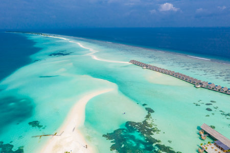 Maldives paradise island. Tropical aerial landscape, seascape with jetty, water bungalows villas with amazing sea lagoon beach. Exotic tourism destination summer vacation backgroudの写真素材