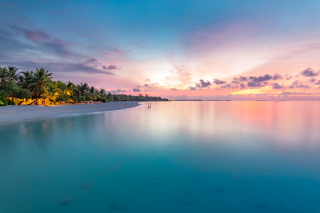 Sunset beach, romantic colors of sky and sea water reflection with horizon. Summer tropical landscape, vacation and holiday destination concept. Inspirational beach sunsetの写真素材