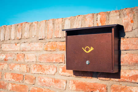 Modern metal mail box on brick stone wall