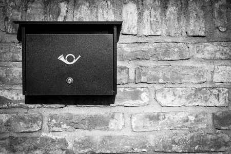 New postbox on modern house wall with iron fence. Mailbox, mail delivery.の写真素材