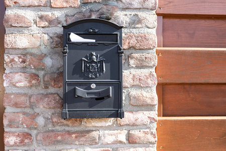Modern metal mail box on brick stone wall