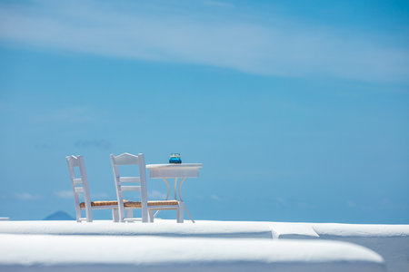 Romantic table setup in Santorini Greece. White architecture, table for two. Love couple romance...