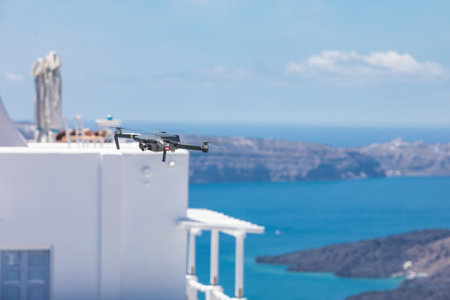 Drone flying over Santorini island, Greece. Selective focus, travel content creator background...