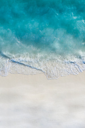 Summer seascape beautiful waves, blue sea water in sunny day. Top view from drone. Sea aerial...