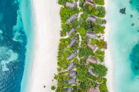 Aerial view on Maldives island. Beautiful sea and coral reef with luxury water villas. Tropical resort, amazing exotic landscape. Summer vacation beach holiday. Tourism destinationの写真素材