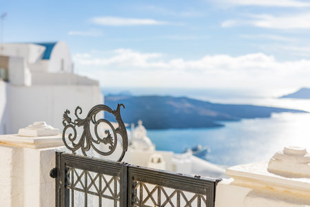 White architecture on Santorini island, Greece. Beautiful landscape with sea view. Iron gate sea view, tranquil summer vacation backgroundの写真素材