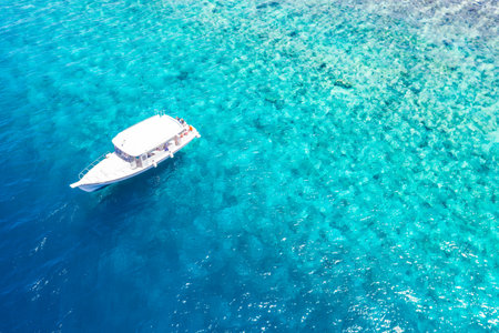 Amazing aerial view tropical island coast with coral beach in Maldives. Luxury yacht beautiful aerial view of blue sea shallow water. Summer vacation holiday concept, exotic travelの写真素材