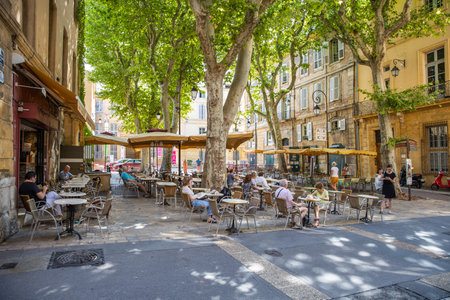 09.07.19 Aix-En-Provence, France: Street with tables of cafe in quarter Provence. Cozy cityscape of centre of south France. Architecture and landmarks of Aix.のeditorial素材