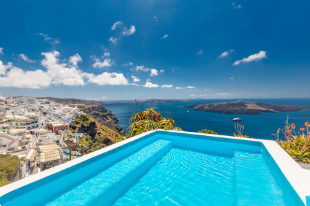 White architecture on Santorini island, Greece. Swimming pool in luxury hotel. Beautiful view, sky over blue sea. Summer vacation and holiday as travel destination, amazing tourismの写真素材