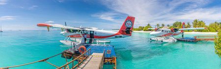 05.19.2021 - Ari Atoll, Maldives: Exotic scene with Trans Maldivian Airways seaplane in luxury resort water dock. Exotic holiday background. Summer vacation transportationのeditorial素材