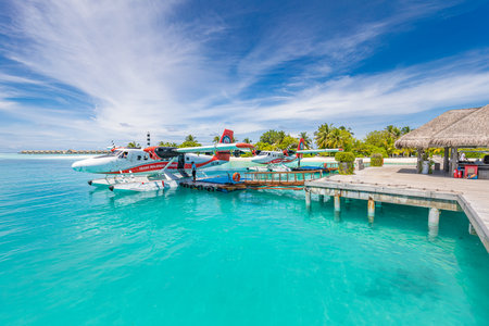 05.19.2021 - Ari Atoll, Maldives: Exotic scene with Trans Maldivian Airways seaplane in luxury resort water dock. Exotic holiday background. Summer vacation transportationのeditorial素材