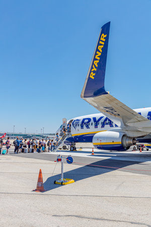 Marseille, France - 07.07, 2019: Passengers boarding Ryanair flight from France to Italy on a sunny day. Ryanair is biggest budget low-cost airline in the world. Low fares airline.のeditorial素材