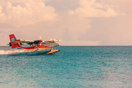 Ari Atoll, Maldives: Exotic scene seaplane on Maldives sea landing. Vacation or holiday in Maldives concept background. Cool sunset exotic transportation, airline as seaplaneのeditorial素材