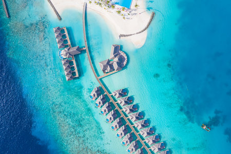 Luxury resort in Maldives. Amazing aerial landscape, sea lagoon. Exotic travel destination and beach villas. Tropical beach landscape coast. Luxury summer vacation aerial viewの写真素材
