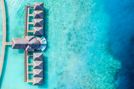 Aerial photo of beautiful paradise Maldives tropical beach on island. Summer and travel vacation wallpaper in luxury resort or hotel. Fantastic aerial landscape view birds eye viewの写真素材