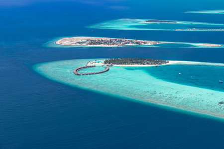 Aerial view of coral reefs in Maldives islands. Tropical aerial landscape. Luxury summer vacation and travel destinationの写真素材