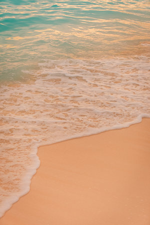 Closeup of tropical waves at sunset. Peaceful beach nature, empty coast view. Sand and soft waves splashingの写真素材