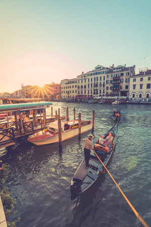 Streets of the ancient city. Beautiful view of traditional gondola and boats on canal grande. Summer vacation and travel tourism scenery. Sunny weather Venice, Italy: 22.09.21のeditorial素材