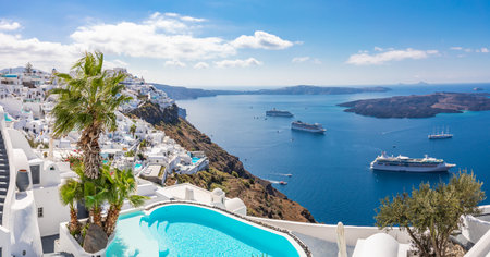 Swimming pool a view on Caldera over Aegean sea, Santorini, Greece at hot sunny summer day. View of caldera and leisure pool in foreground, typical white architectureのeditorial素材