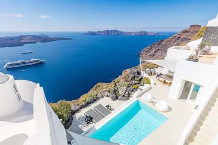 Swimming pool with a view on Caldera over Aegean sea, Santorini, Greece at hot sunny summer day. View of caldera and pool in foreground, typical white architectureのeditorial素材