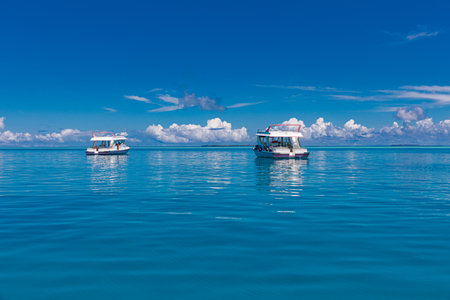 Boats on the turquoise water of the Indian Ocean, Maldives. Calm ocean bay, travel tourism snorkel...