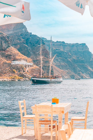 two gullet sailing vessels moored at the old port at Fira. Summer travel scenery and adventure, outdoor view. Vacation landscape and sea view Fira, Santorini, Greece - 10.10.21のeditorial素材