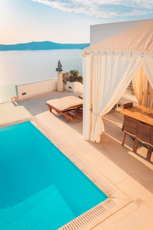 Luxury lifestyle, sunset tourism destination. Summer travel vacation, landscape of Santorini island. Famous travel destination, amazing Mediterranean luxurious pool and view 07.15.のeditorial素材