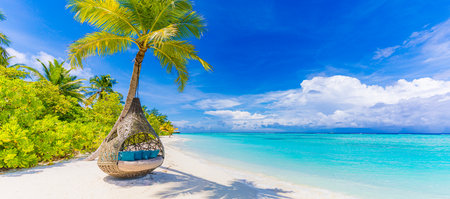 Tropical beach paradise as summer landscape, beach swing hammock and white sand, calm sea serene beach. Luxury resort vacation. Exotic tranquil island nature travel destinationの写真素材