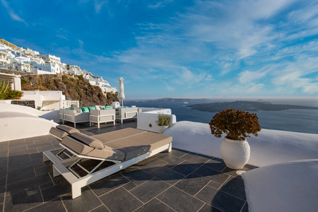 Santorini island, Oia caldera, two sun beds, loungers, amazing sunny sea horizon recreational calm relax. Inspirational beach resort hotel. Luxury Greece travel vacation. 24.07.21のeditorial素材