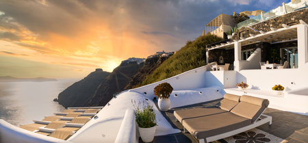 Santorini island, Oia caldera, two sun beds, loungers, amazing sunny sea horizon recreational calm relax. Inspirational beach resort hotel. Luxury Greece travel vacation. 24.07.21のeditorial素材