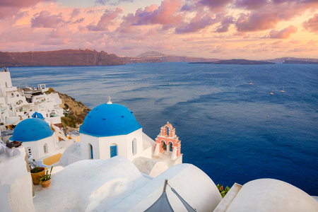 Europe summer destination. Traveling concept, sunset famous landscape of Santorini island, Oia, Greece. Caldera view, colorful clouds, dream cityscape. Vacation panorama, amazingの写真素材