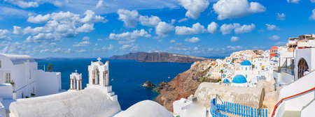 Beautiful Santorini, Oia village panorama. Summer travel and vacation. Luxury panoramic coast, white architecture and blue sea sunny sky, pools, loungers. Luxury summer landscapeの写真素材