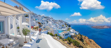 Amazing sunny Fira, caldera, volcano of Santorini, Greece. Stunning travel landscape, summer romantic couples vacation destination. White architecture, colorful street blue skyの写真素材