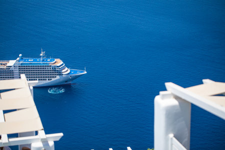 Beautiful view of picturesque town of Thira, caldera and volcano on the Mediterranean Sea. Traditional white architecture of the island of Santorini, Greece. Summer holiday tourismの写真素材