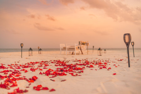 Amazing romantic dinner on beach candles flowers under sunset sky. Romance love, luxury destination dinning, exotic table setup sea view. Honeymoon celebration anniversary designの写真素材