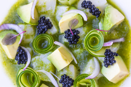 Luxury gourmet food. Elegant gourmet white plate top view lunch dinner dish meal as fine dining closeup green cucumber avocado seafood beautiful modern cuisine, modern restaurantの写真素材