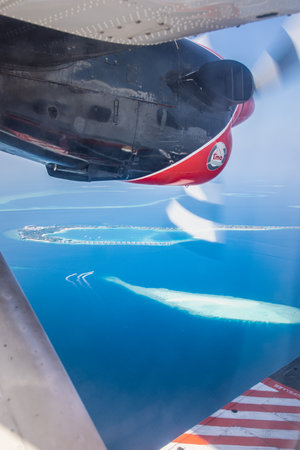 Amazing view from seaplane in Maldives islands, atolls and tropical island resorts from above. Travel landscape, plane window view. Exotic summer vacation, traveling. 03.24.23のeditorial素材
