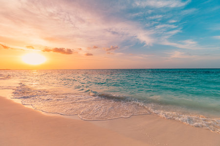 Closeup sea sand beach. Panoramic beach landscape. Inspire tropical beach seascape horizon. Orange gold sunset sky calmness tranquil relaxing sunlight summer mood. Vacation travelの写真素材