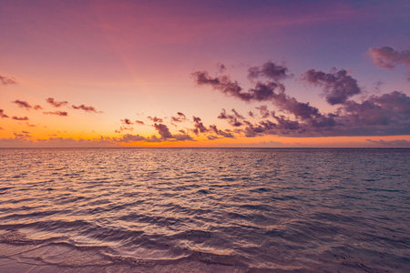 Closeup sea water surface. Panoramic beach landscape. Inspire tropical beach seascape horizon. Orange beautiful golden sunset sky calmness tranquil relaxing sunlight summer moodの写真素材