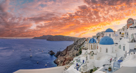 Europe summer destination. Traveling sunset famous landscape of Santorini island, Oia, Greece. Caldera colorful clouds, dream cityscape. Vacation panorama, amazing outdoor sceneの写真素材
