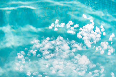 Bokeh light background in the pool. Natural bokeh blue water sunny abstract closeup dream travel...