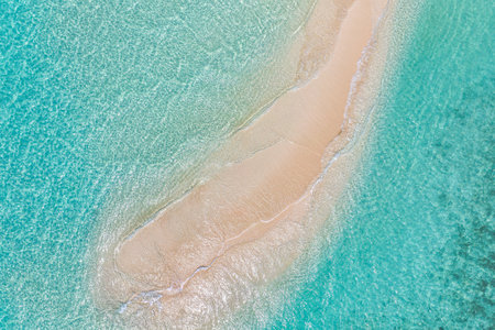 Summer seascape beautiful waves, blue sea water in sunny day. Top view from drone. Sea aerial amazing tropical nature background. Beautiful bright sea waves splashing beach sandの写真素材