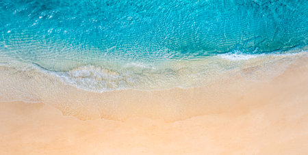 Summer seascape beautiful waves, blue sea water sunny day. Top view from drone. Sea aerial view, amazing tropical nature background. Beautiful bright sea waves splashing beach sandの写真素材