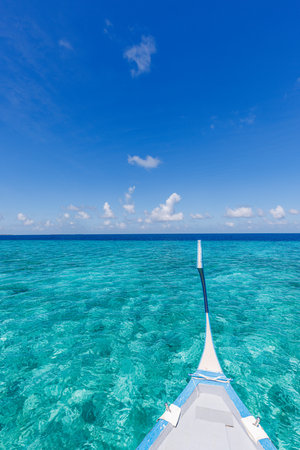 Amazing Maldives beach. Maldives traditional boat Dhoni front. Blue sea ocean lagoon. Luxury tropical paradise concept. Beautiful vacation travel landscape. Tranquil ocean lagoonの写真素材