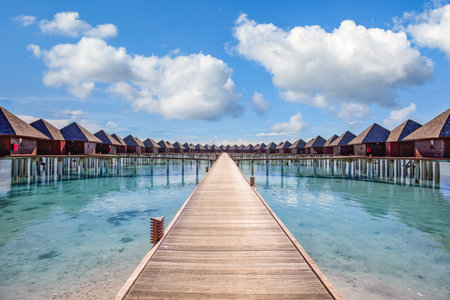 Beautiful water villa lagoon and blue sky space. Panoramic summer landscape, ocean lagoon relaxing idyllic cloudy blue sky. Exotic luxury travel background. Amazing Maldivesの写真素材