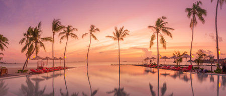 Tropical sunset silhouette outdoor infinity pool summer seaside resort, beach landscape. Luxury tranquil beach holiday poolside reflection relax chaise lounge romantic colorful skyの写真素材