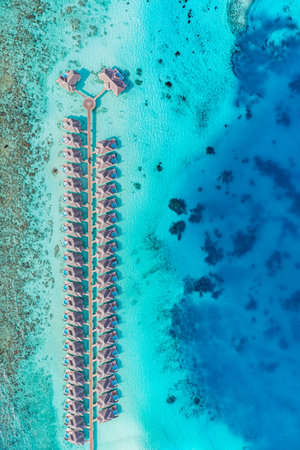 Maldives paradise island. Tropical aerial top view landscape, seascape water bungalows villas amazing sea lagoon beach. Exotic tourism destination, summer vacation backgroundの写真素材